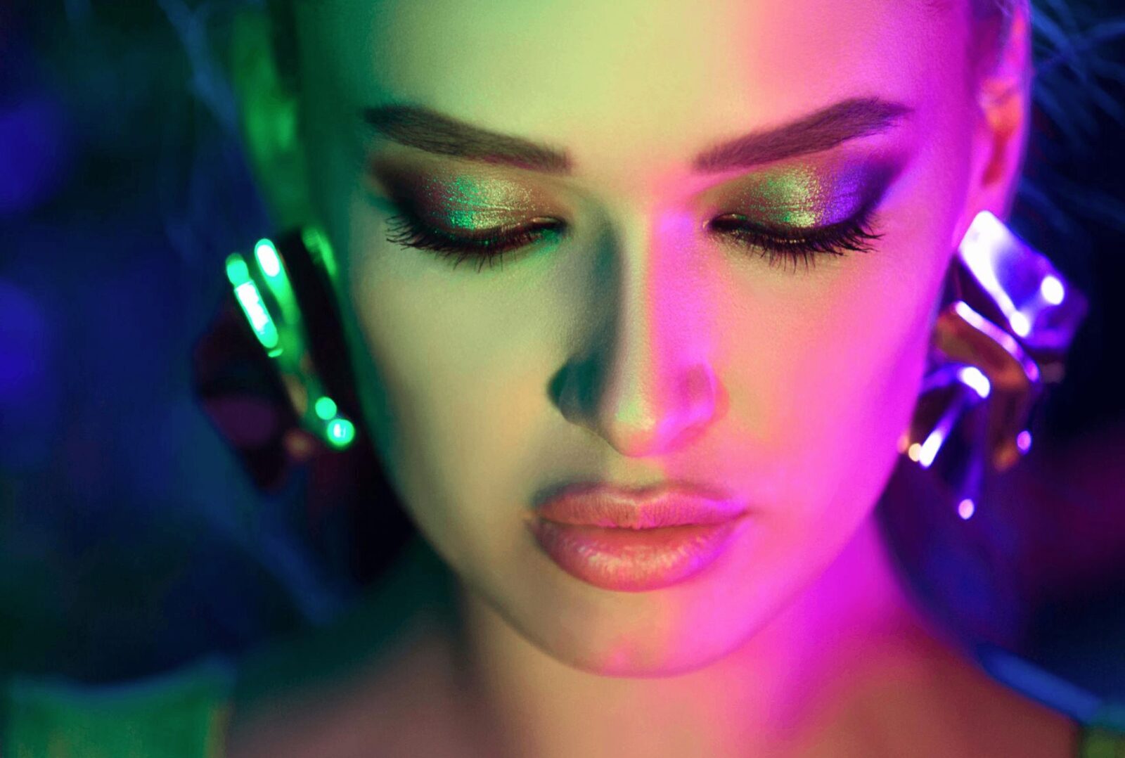 Close-up portrait in green and magenta light
