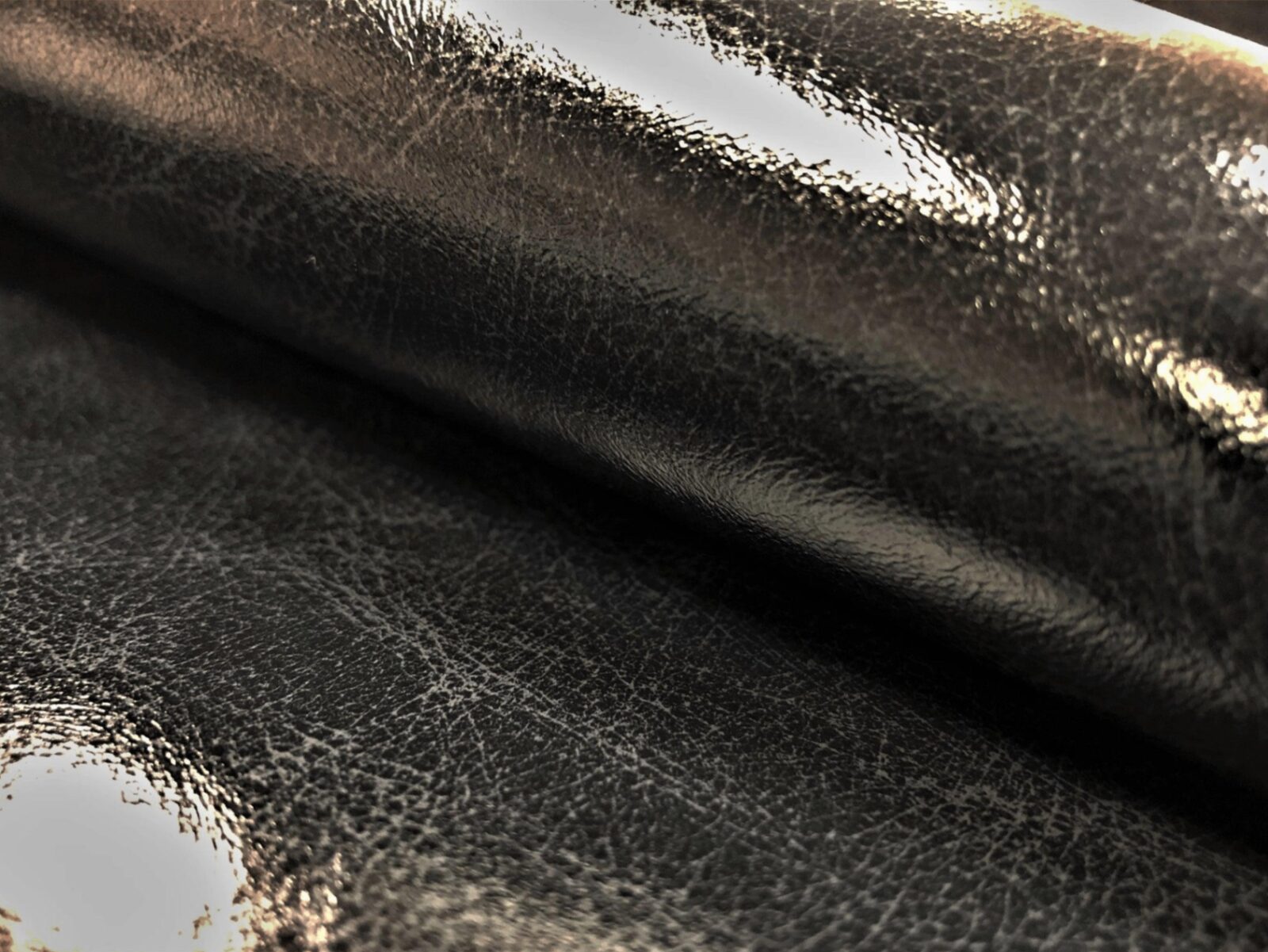 Glossy distressed black leather